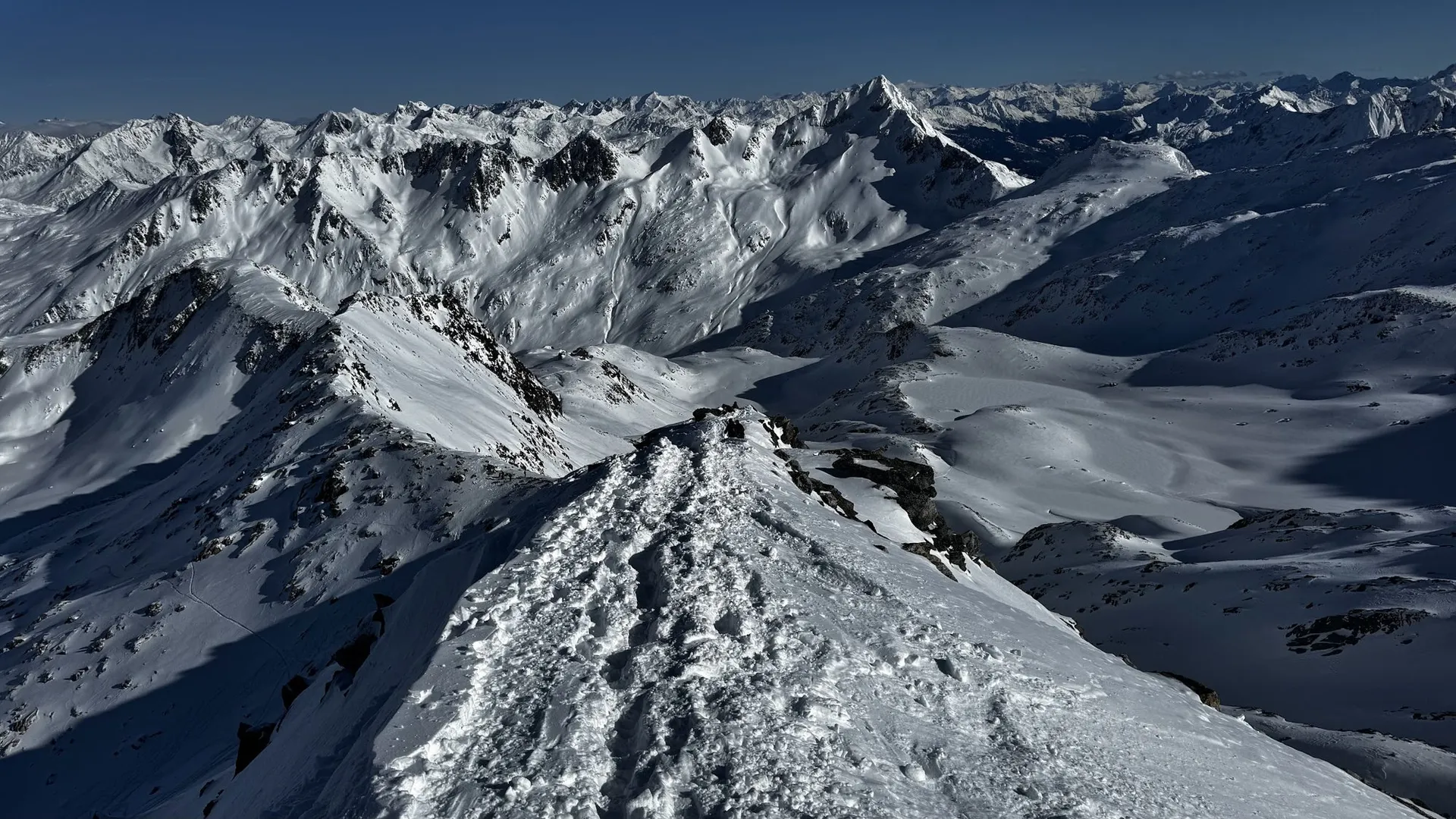 Snowy peaks seen from a summit ridge in the Swiss Alps